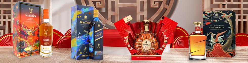 Edited photographs of Glenfiddich Gran Reserva, Johnnie Walker Blue Label, Remy Martin XO and Johhnie Walker & Sons Chinese New Year limited edition bottles on a woden surface with Chinese decorations in the background
