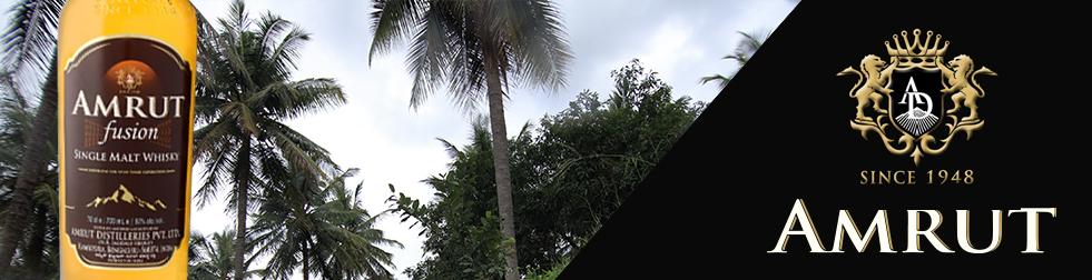 Image of the Amrut logo next to photographs of palm trees surrounding the Amrut Distillery and a bottle of Amrut Fusion Whisky