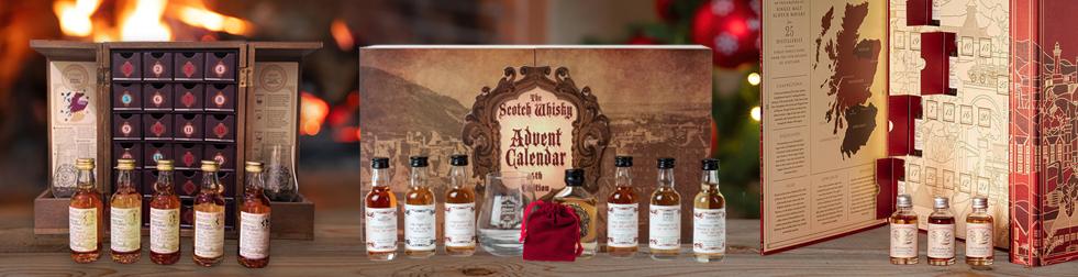 Edited photograph of three advent calendars on a wooden desk with some windows open, showcasing some of the miniatures included in them